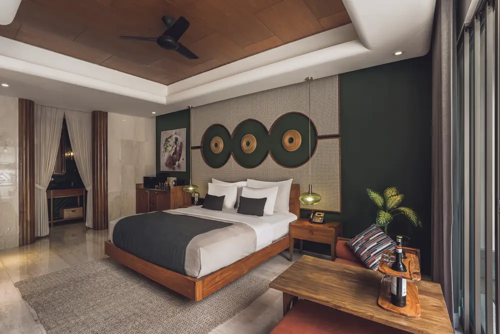 Contemporary luxury resort suite featuring Balinese art decor and king bed curated by Bali Assist Co