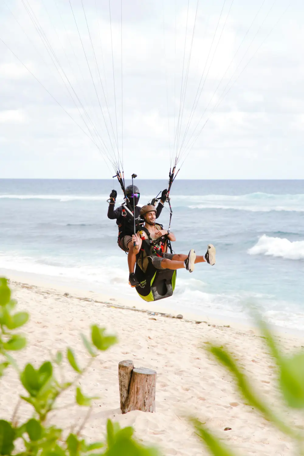 Tandem paragliding experience over the scenic Bali coastline booked through organized by Bali Assist Co luxury tour