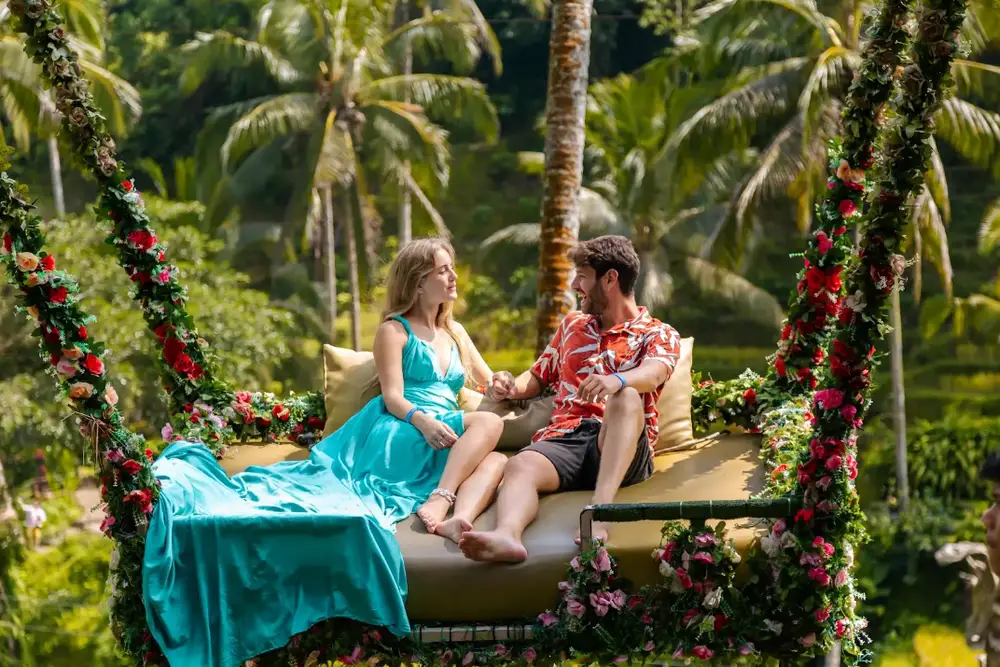 Couple relaxing on outdoor daybed with rice terrace view at Alas Harum Ubud for The Grand Escape by Bali Assist Co