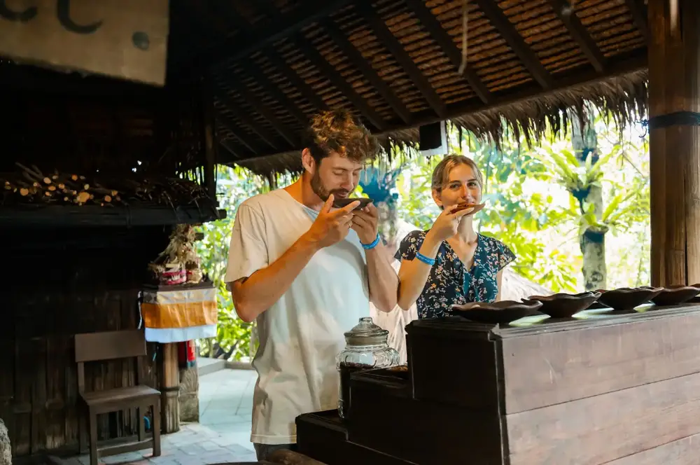 Man tasting fresh authentic Luwak coffee during farm tour in Ubud for The Grand Escape by Bali Assist Co