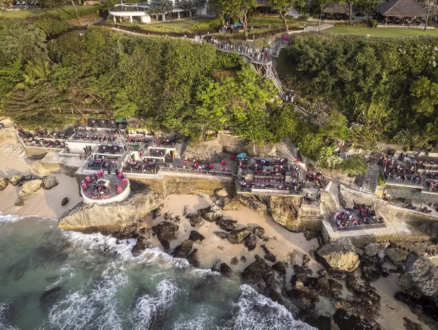 Coastline view of Rock Bar built on natural rock formations in Jimbaran Bali by Bali Assist Co