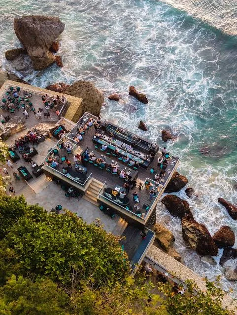 Aerial top-down view of Rock Bar Jimbaran on the ocean cliff edge for The Grand Escape Day 10 by Bali Assist Co