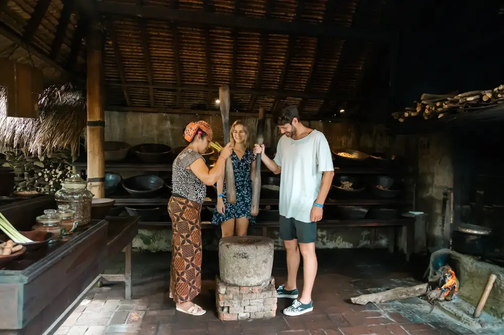 Couple learning traditional Luwak coffee grinding with local guide at Alas Harum Ubud by Bali Assist Co