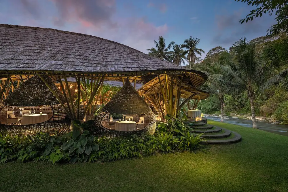 Private romantic dinner inside a bamboo cocoon dining space beside Ayung river at Kubu at Mandapa for The Indulgence by Bali Assist Co