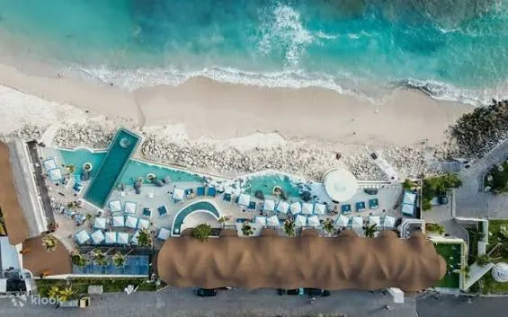 Aerial drone shot of beachfront pool and beach club at Melasti Beach for The Indulgence by Bali Assist Co