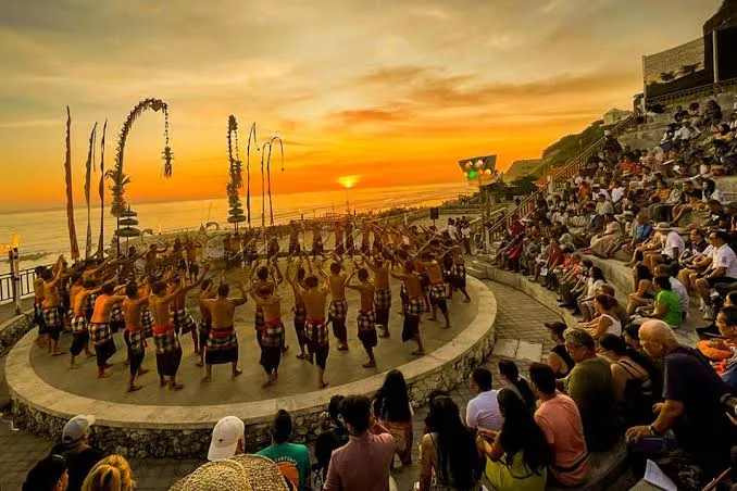 Performers executing Kecak dance at sunset cliffside amphitheater on Melasti Beach by Bali Assist Co