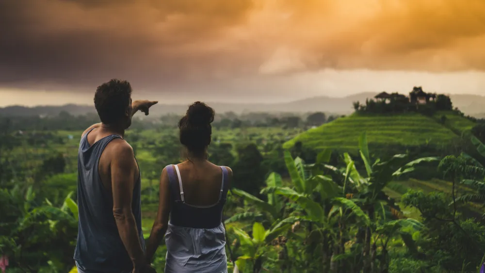 Couple enjoying lush green tropical jungle views in Bali for The Journey travel package by Bali Assist Co