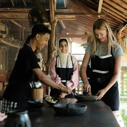 Travelers learning to prepare Balinese traditional dishes with a local chef for The Journey Day 4 by Bali Assist Co