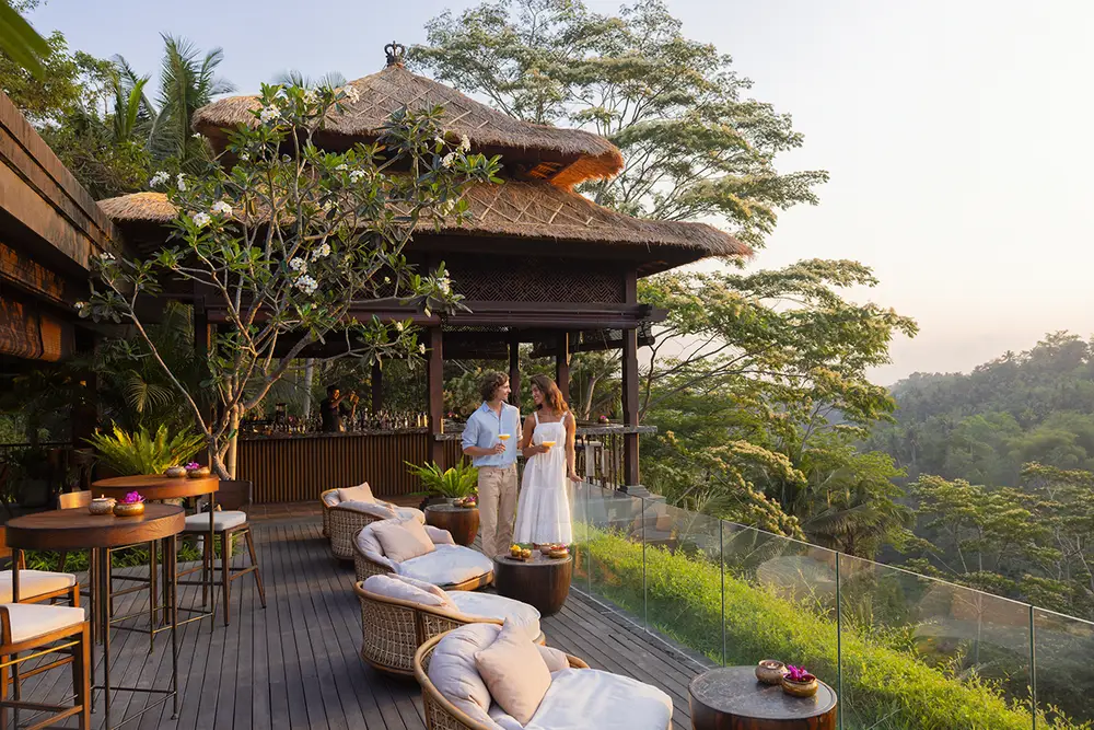 Couple enjoying drinks at Ambar Ubud outdoor lounge overlooking the forest for The Signature Journey Day 5 by Bali Assist Co