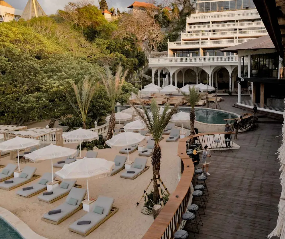 Beachfront pool and sun loungers at Canna Bali beach club in Nusa Dua for The Signature Journey by Bali Assist Co