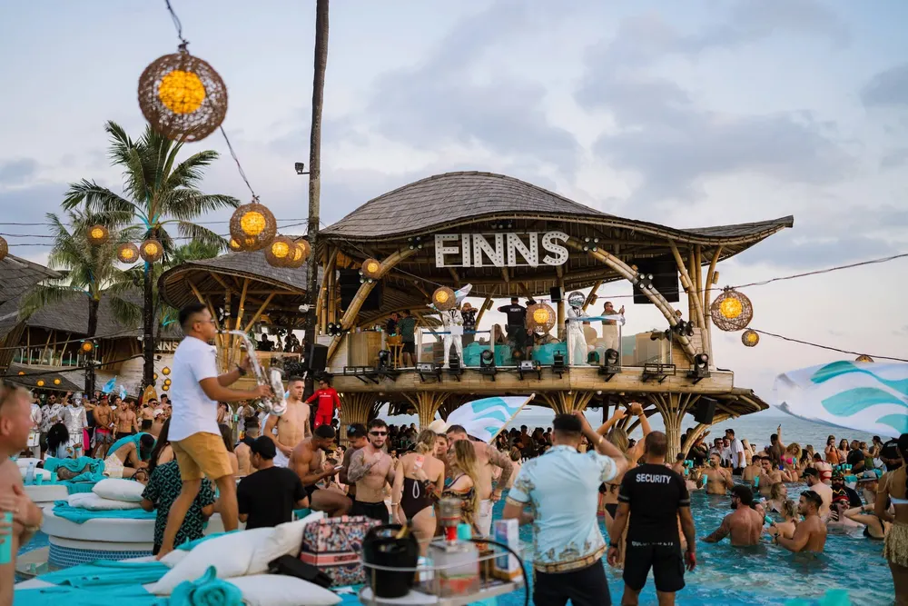 Iconic bamboo architecture and crowd at Finns Beach Club Canggu for The Signature Journey by Bali Assist Co