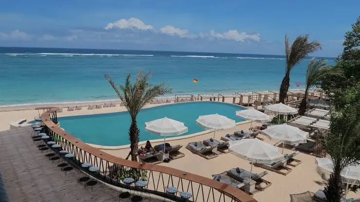 Luxury beachfront resort in Nusa Dua overlooking turquoise ocean waters by Bali Assist Co