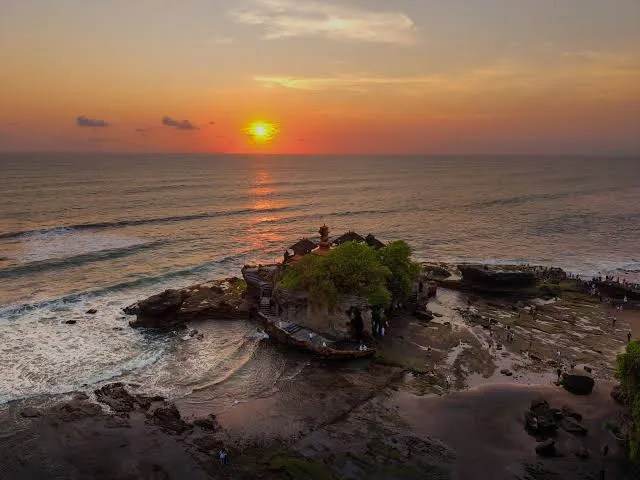 Golden hour sunset behind Tanah Lot temple offshore rock by Bali Assist Co