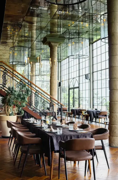 Elegant interior dining space with high ceilings at The Cliff at Canna Bali by Bali Assist Co