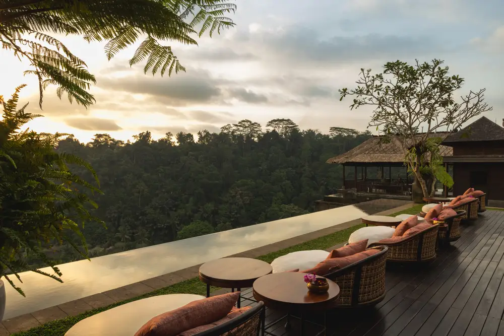 Open-air deck lounge at Ambar Ubud with sunset views over Ayung River jungle valley for The Ultimate Bali Journey Day 9 by Bali Assist Co