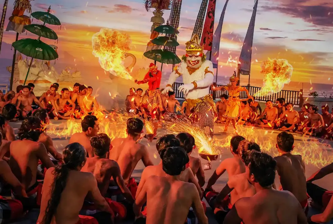 Traditional Balinese Kecak fire dancer performance at dusk on Melasti Beach by Bali Assist Co