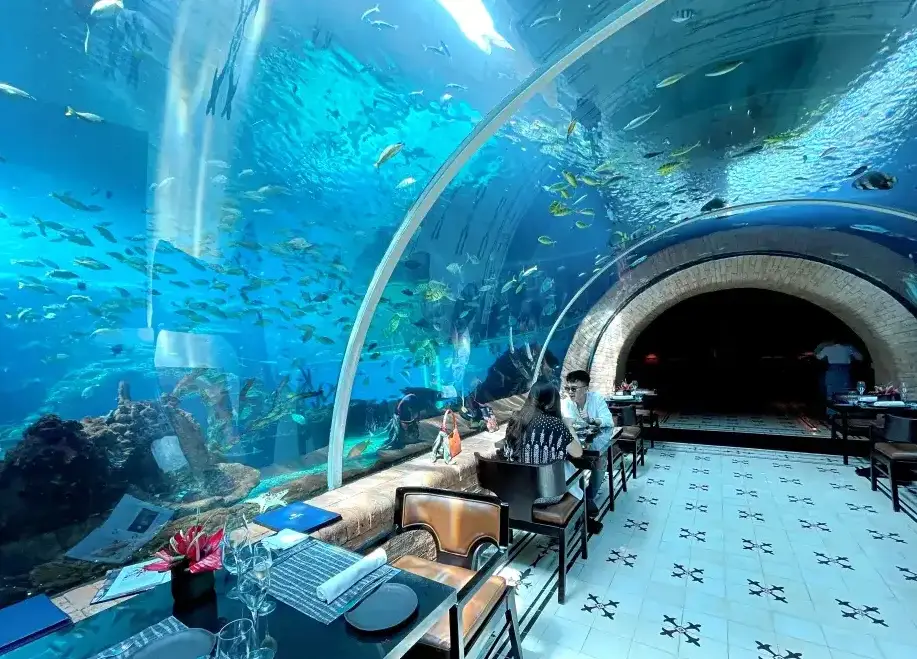 Fine dining table set inside Koral underwater aquarium restaurant at The Apurva Kempinski Bali by Bali Assist Co