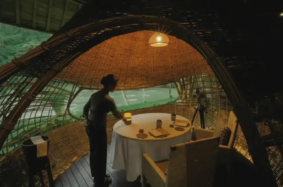 Private romantic dinner inside bamboo cocoon structure at Kubu at Mandapa Ubud by Bali Assist Co