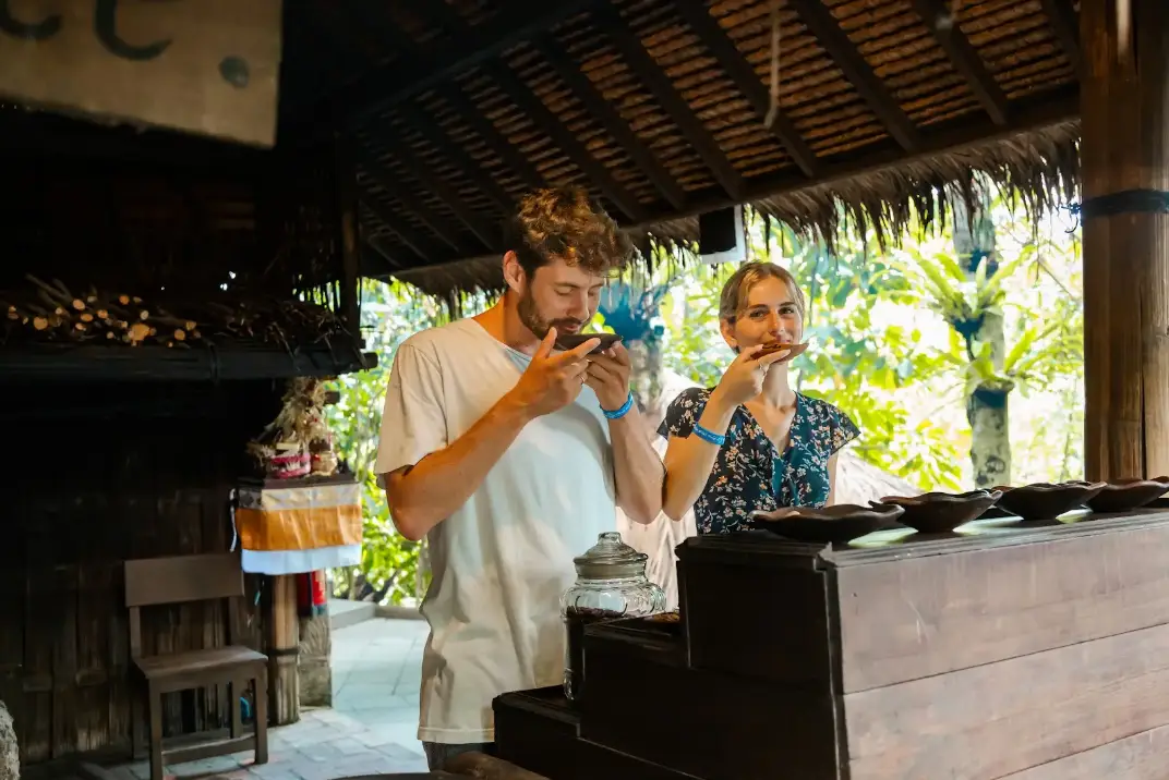 Tourist smelling fresh roasted coffee during Luwak coffee tasting tour at Alas Harum Ubud by Bali Assist Co