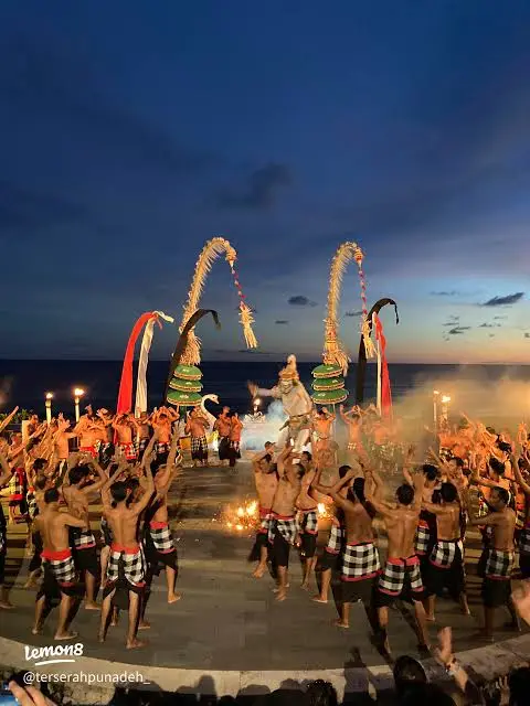 Dancers performing traditional Kecak and Fire Dance at sunset amphitheater on Melasti Beach by Bali Assist Co