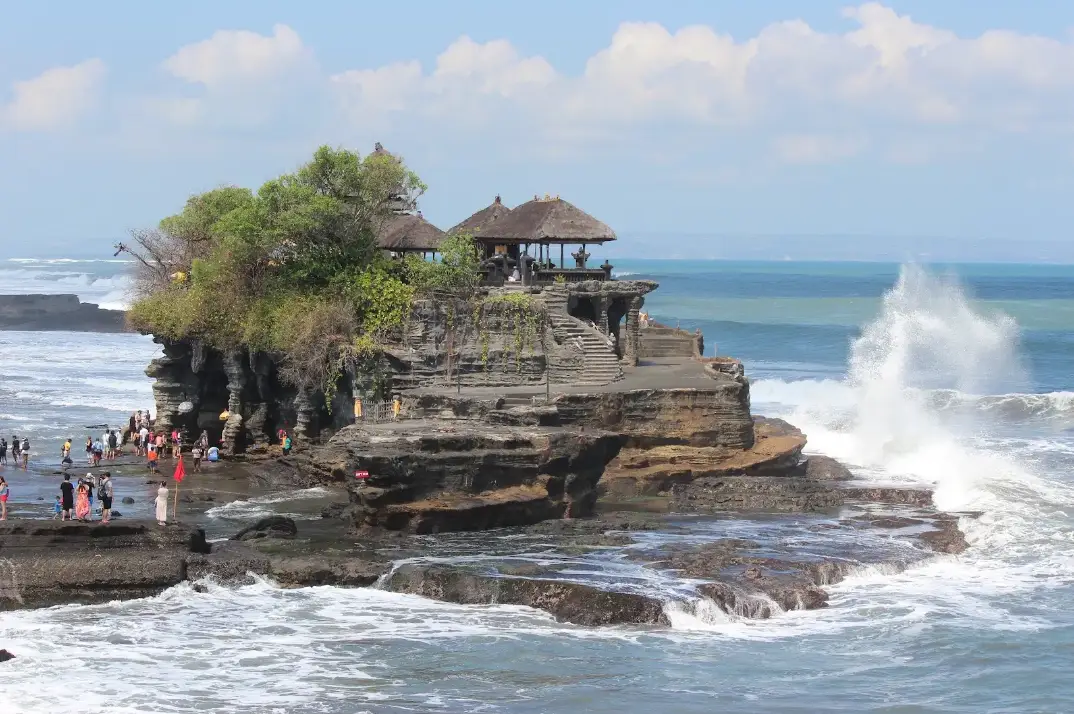Tanah Lot sea temple sitting on natural rock formation in the ocean for The Ultimate Bali Journey Day 4 by Bali Assist Co