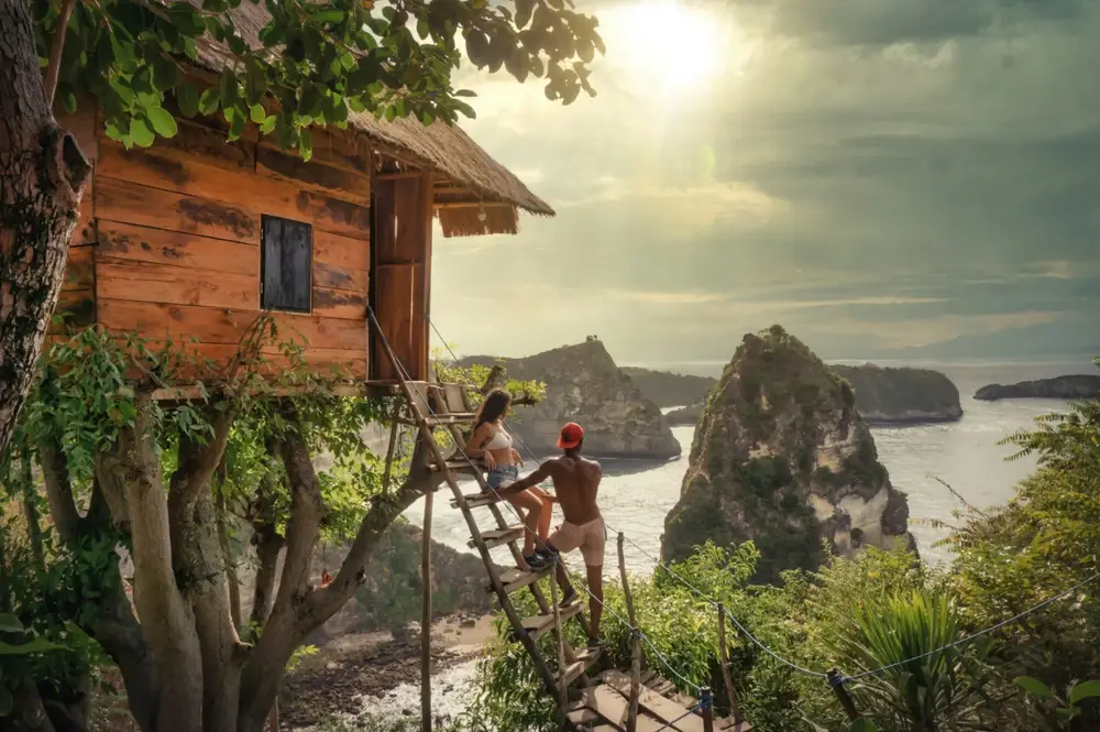 Couple enjoying scenic cliff views from Molenteng Treehouse Nusa Penida for The Ultimate Bali Journey by Bali Assist Co