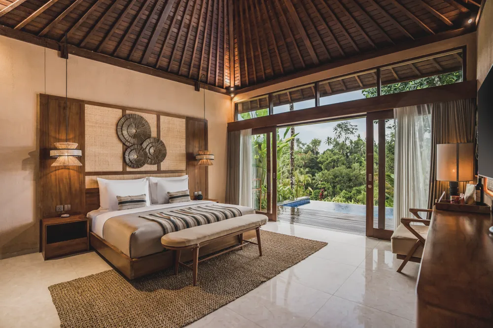Authentic wooden pavilion villa bedroom overlooking private pool and jungle views in Bali by Bali Assist Co