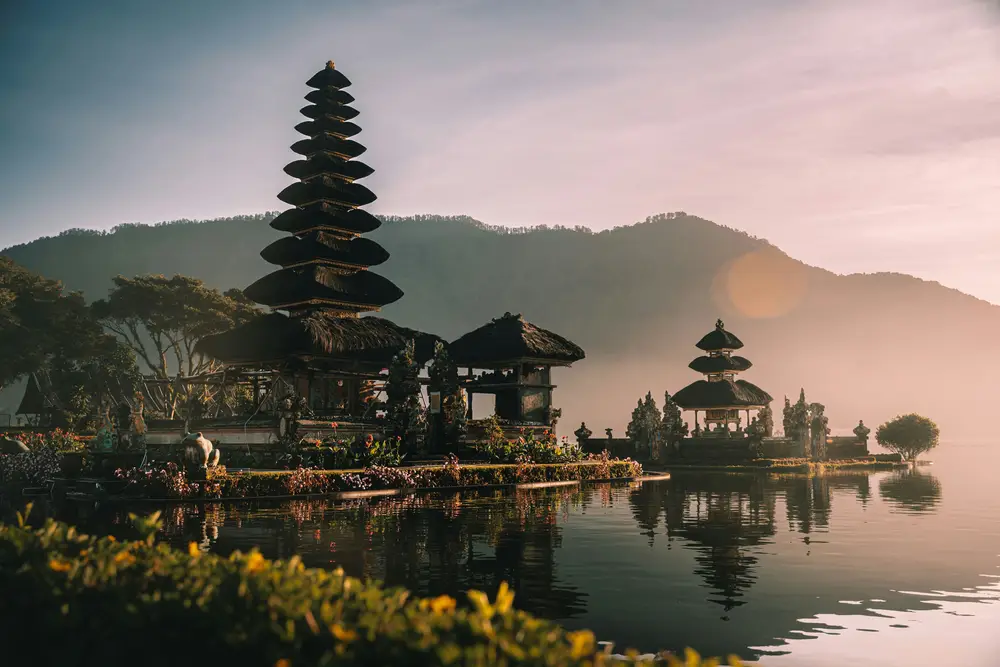 Ulun Danu Bratan water temple surrounded by lake and mountains in Bedugul Bali organized by Bali Assist Co luxury tour
